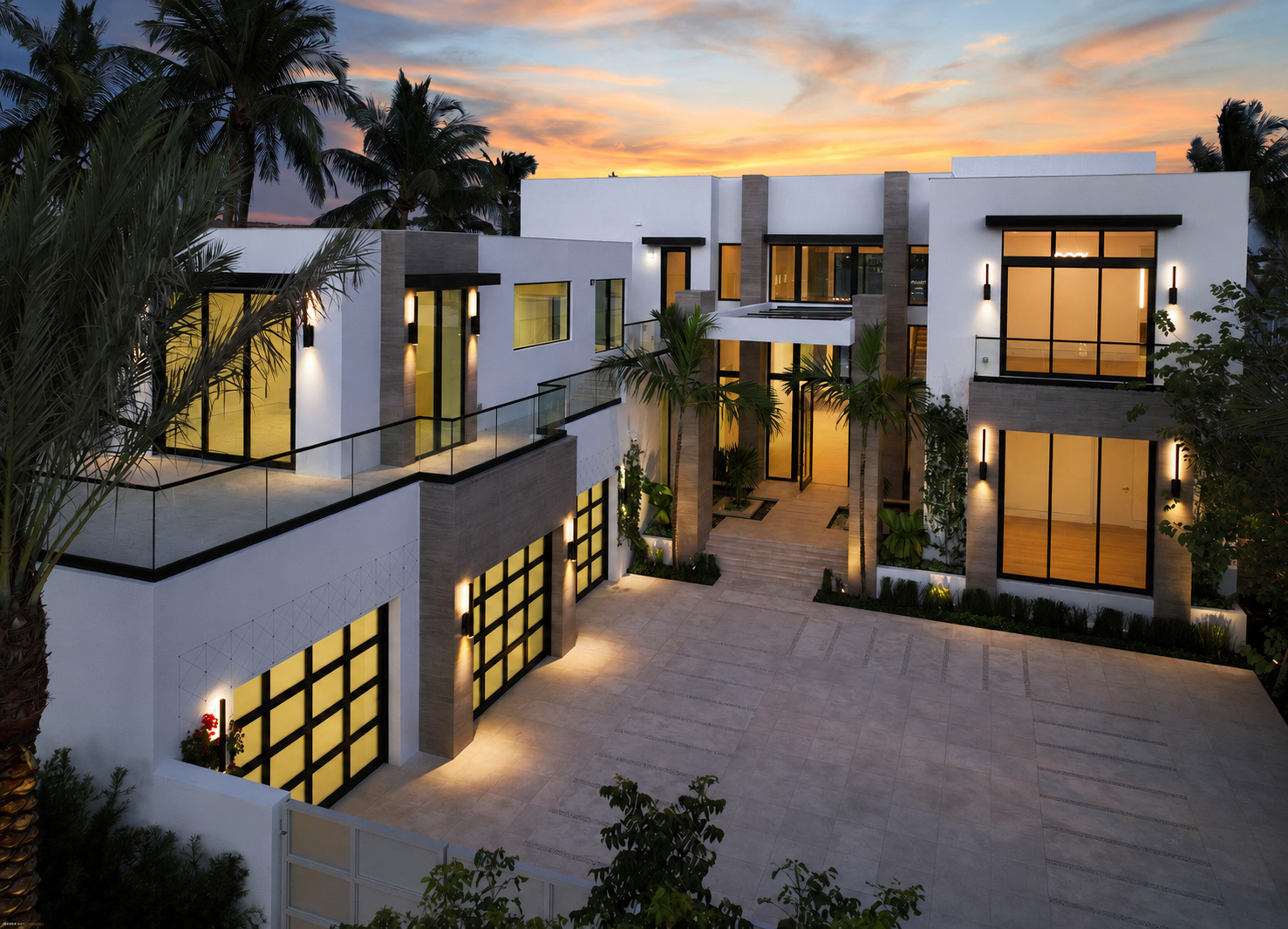 Front exterior view of the North Flagler waterfront estate at sunset.